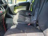 the interior of a van with the seat up and the front seats down