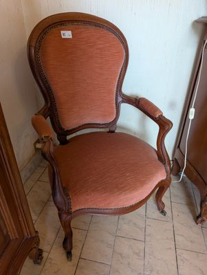 a chair that is sitting next to a cabinet