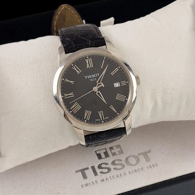 a black watch with roman numerals on it in a box