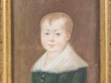 portrait of a young boy in a green dress