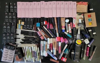 a lot of makeup and eyeliners laid out on a table