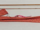 two different types of fishing rods on a table