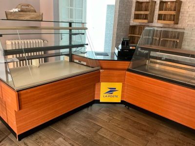 a display case in the middle of a room with wooden flooring