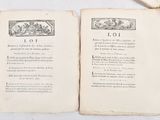 two open books on a table with a bookmark on top of them