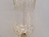 a glass with a flower design on it on a table