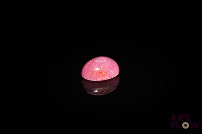 an image of a pink stone in the dark