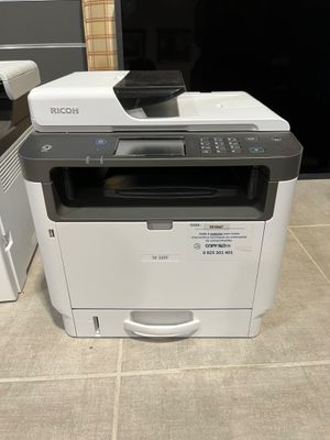 a printer that is sitting on the floor next to a printer