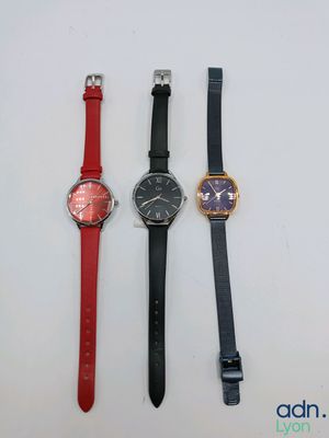 three different watches are lined up on a white surface