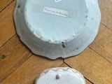 a white plate and a white bowl on a wooden floor