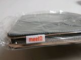 a laptop that is wrapped in plastic on a table