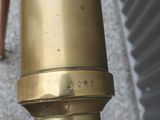 a close up of a brass colored telescope on a pole