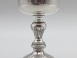 a silver cup on a pedestal on a white background