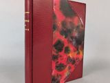 a book with a red cover sitting on top of a table
