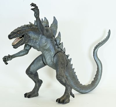 a godzilla figure that is standing on a white surface