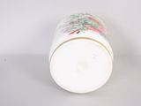 a white cup with a floral design on it