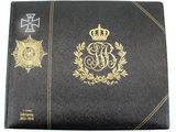 a close up of a black book with a gold emblem on it