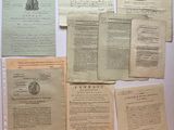 some old papers are sitting on a table with a pen