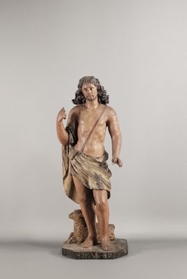 une vieille statue représentant un homme barbu tenant un sac