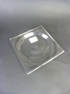 a glass plate on a table with a black background