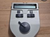une calculatrice posée sur une table en bois à côté d'un téléphone portable