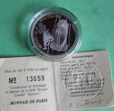 a silver coin with a picture of a man and a woman on it