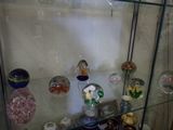 a glass display case with a lot of glass items on it