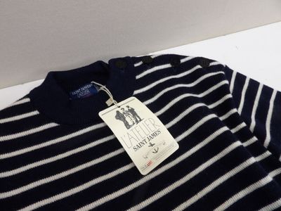 navy blue and white striped sweater with a tag on it