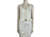 the mannequin is wearing a white dress and a white jacket