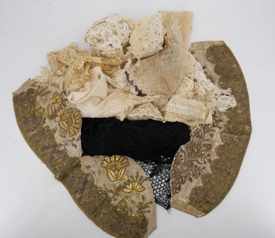 a hat made out of old clothes on a white surface