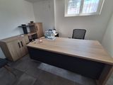 a desk and chair in a room with a window