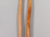 two wooden sticks sitting next to each other on a table
