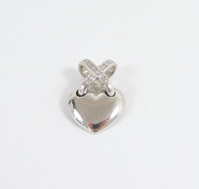 a silver heart charm with a cross on it