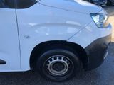 a small white van parked in a parking lot