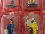 six action figures in plastic cases on a white surface