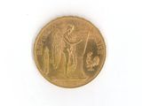 a gold coin with an image of a man holding a sword