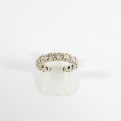 a close up of a diamond ring on a white surface