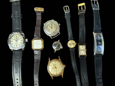many different types of watches on a black background
