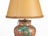 a lamp that is sitting on a table with a lamp shade on it