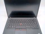 the laptop is open on a white surface with a black keyboard