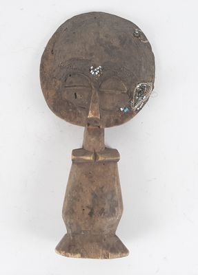 an image of a wooden sculpture of a woman with a flower in her hair