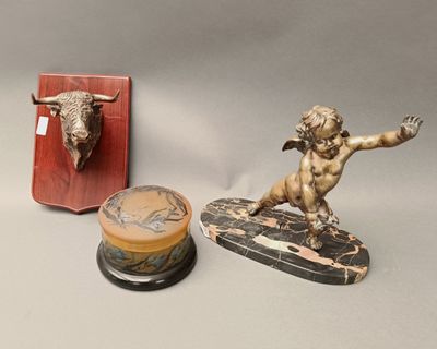a statue of a man on a surfboard next to a box with a bull head on it