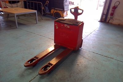 a fork lifter that is sitting in the garage