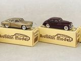 four small toy cars are sitting in a row on top of a box