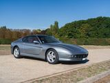 a silver sports car parked on the side of the road