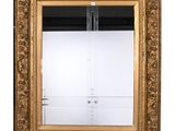 an ornate gold framed mirror with a clear glass door