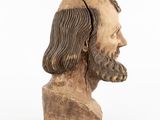 wooden bust of a man with long hair and beard on a white background