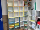 a room that has a bunch of boxes on the shelves