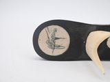a close up of a pair of shoes with a plant on the sole