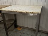 a dirty table in the corner of a bathroom
