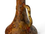 a brown vase with a handle on a white surface
